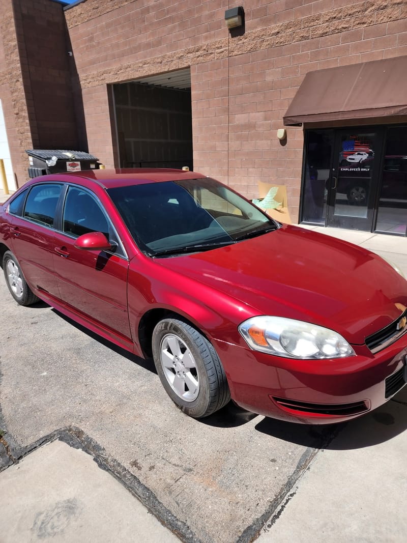The same Impala outside the shop with the front fender and door straight again, the body line continuous